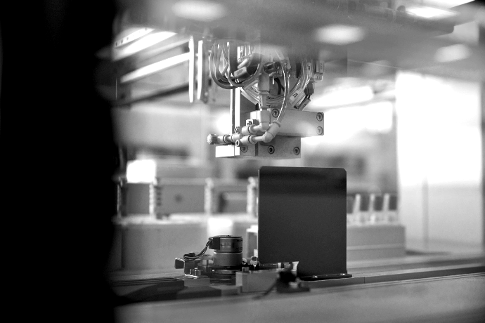 Production Ready industrial robotic arm in blue lit factory